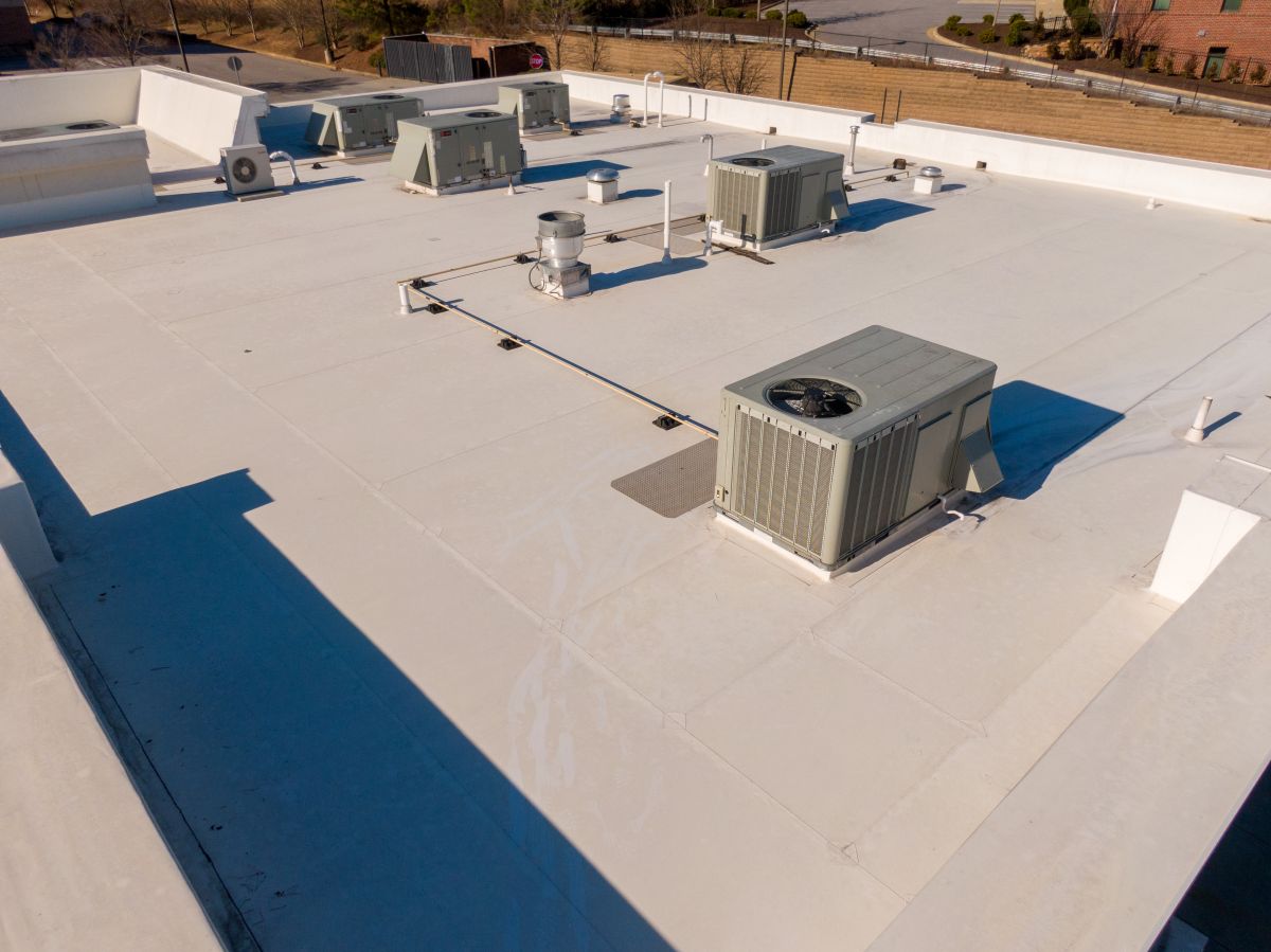 white flat commercial roof with big vents