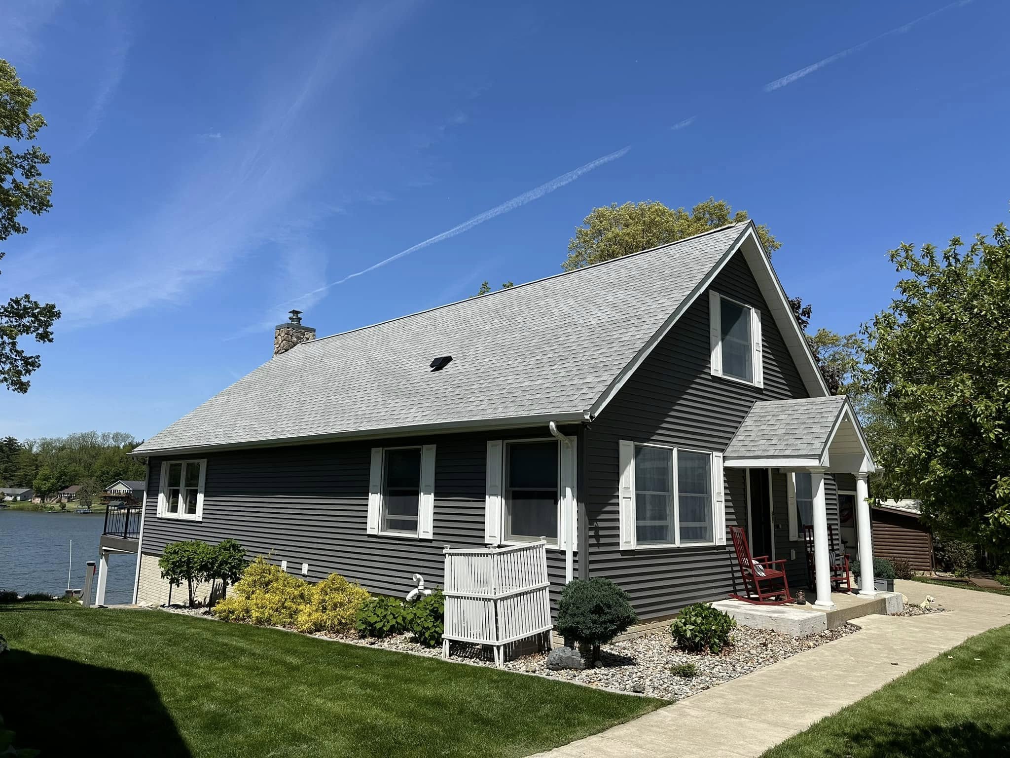 a house with newly installed grey shingles