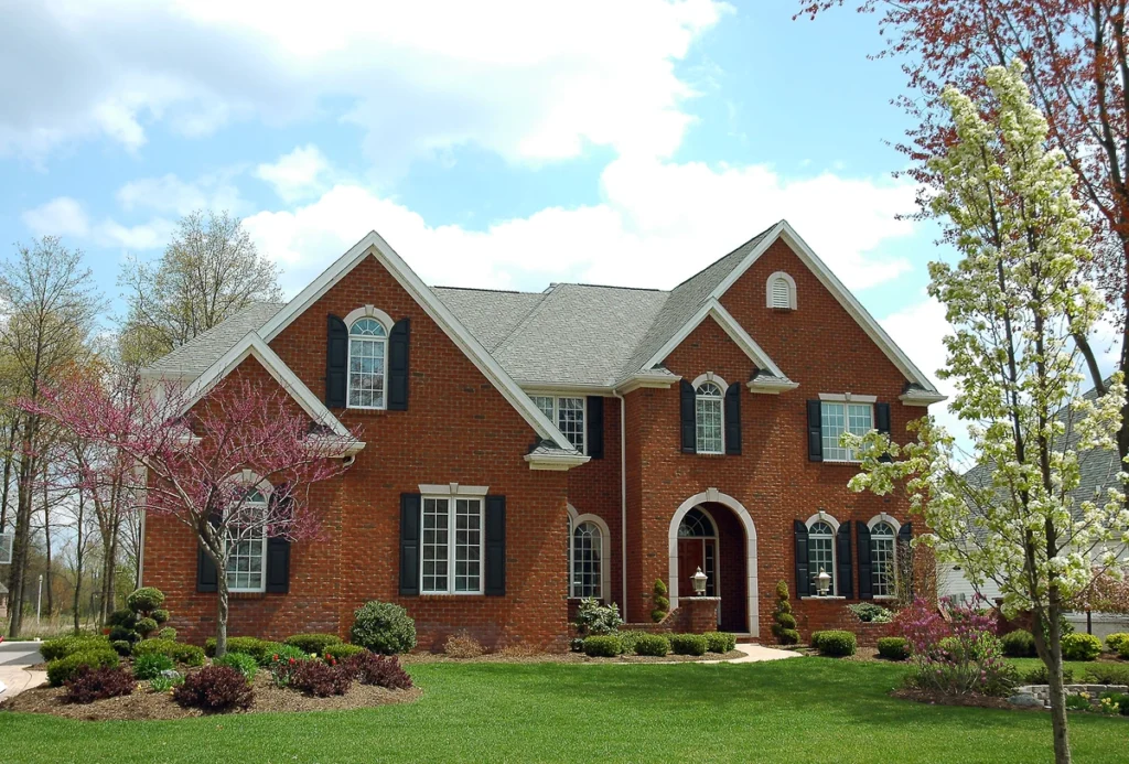 brick house with shingle roof